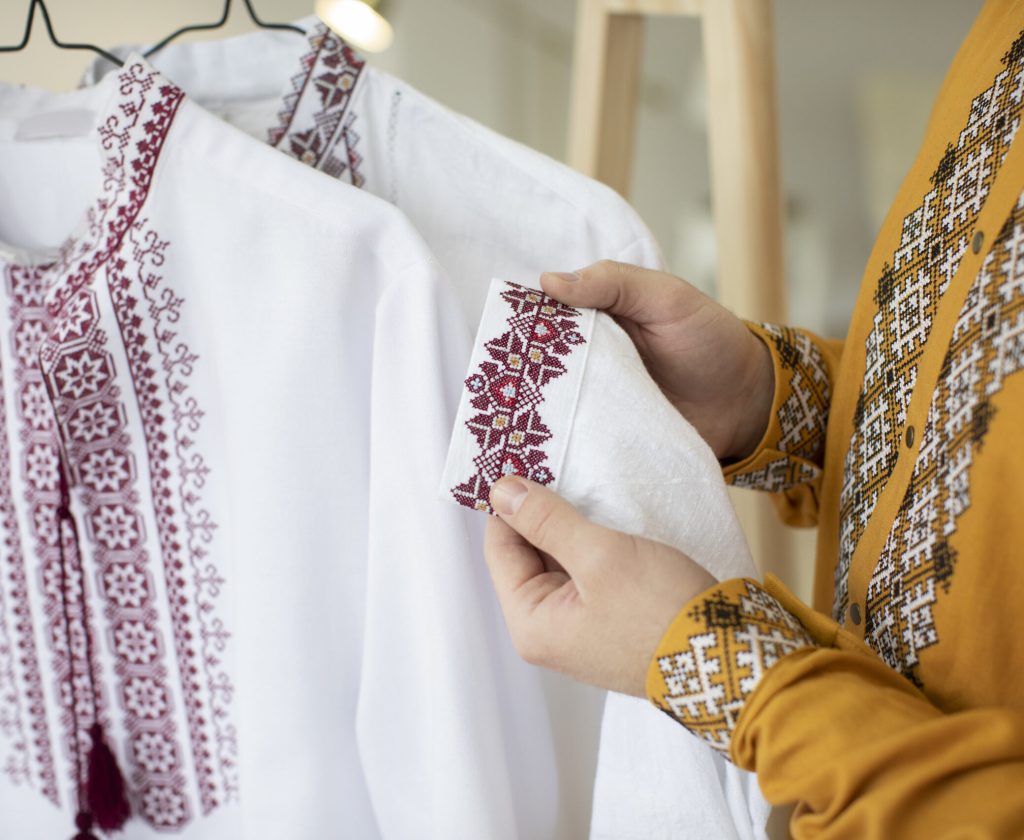 close-up-hands-holding-embroidered-shirt